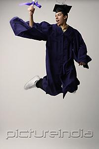 PictureIndia - Graduate jumping for joy