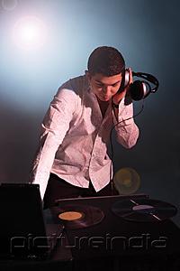 PictureIndia - Young man working as DJ