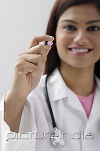 PictureIndia - Doctor holding up a pill