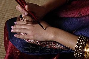 PictureIndia - Indian woman painting hand with henna