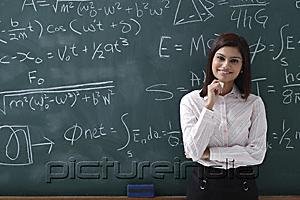 PictureIndia - Woman standing proudly in front of chalk board