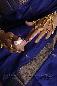 PictureIndia - Indian woman painting finger nails