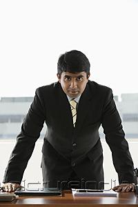 PictureIndia - business man standing at desk