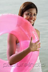 PictureIndia - woman at beach with pink tube