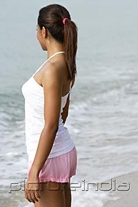 PictureIndia - Side view of woman looking at ocean