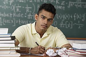 PictureIndia - young man sitting at his desk, writing