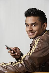 PictureIndia - young man using mobile phone