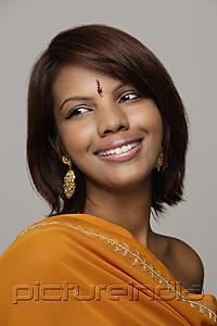 PictureIndia - Woman wearing orange sari and bindi smiling