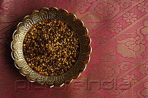 PictureIndia - Indian digestive mukhwa seeds on brass dish on pink sari cloth