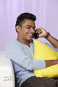PictureIndia - young man talking on mobile phone, relaxed