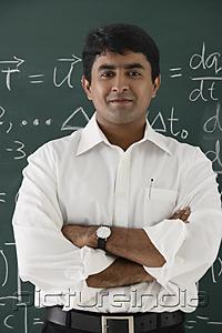 PictureIndia - teacher standing in front of chalkboard, arms crossed