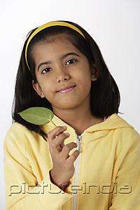 PictureIndia - Girl holding leaf