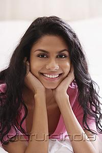 PictureIndia - Portrait of Indian woman holding face and smiling