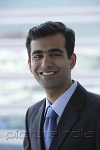 PictureIndia - Portrait of Indian businessman smiling.