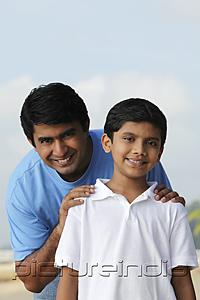 PictureIndia - Father holding sons shoulders and smiling