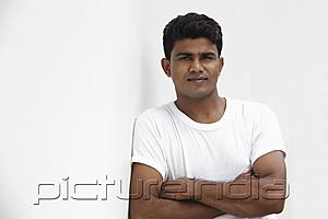 PictureIndia - Man leaning against white wall