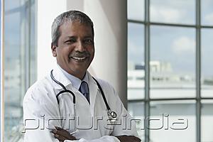 PictureIndia - Head shot of Indian doctor smiling