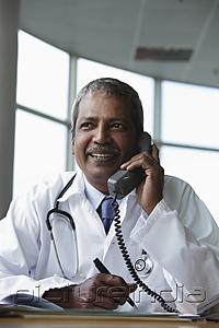 PictureIndia - Indian doctor talking on phone and smiling