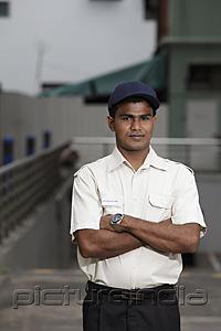 PictureIndia - Security guard standing with arms folded