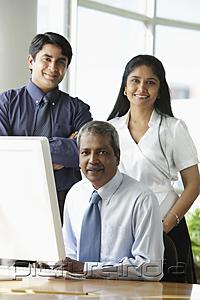 PictureIndia - Indian business people smiling in front of computer.