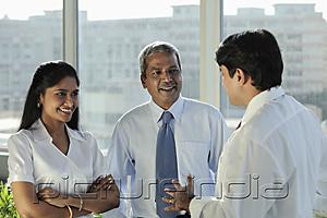 PictureIndia - Three Indian people talking together and laughing