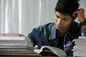 PictureIndia - young man reading a book, studying