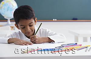 Asia Images Group - boy concentrates on schoolwork