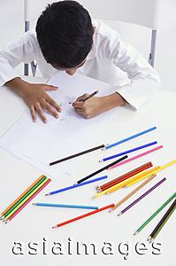 Asia Images Group - boy works with colored pencils (top view)