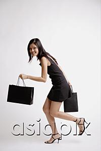 AsiaPix - Young woman carrying shopping bags