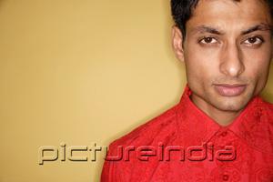 PictureIndia - Man looking at camera, yellow background