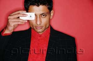 PictureIndia - Man looking through camera phone