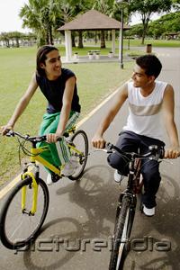 PictureIndia - Two young men cycling side by side