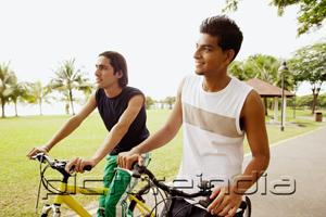 PictureIndia - Two young men on bicycles, looking away