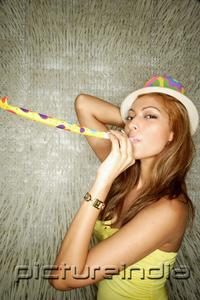 PictureIndia - Young woman with party hat and noisemaker