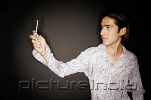 PictureIndia - Young man looking at mobile phone, arms outstretched