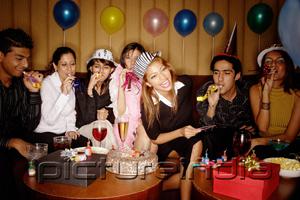 PictureIndia - Young adults celebrating birthday, wearing party hats