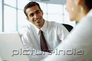 PictureIndia - Executive smiling at another person