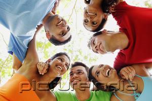 PictureIndia - Group of young adults arms around each other, smiling at each other