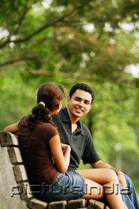 PictureIndia - Couple sitting on bench, talking