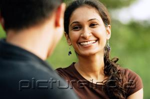PictureIndia - Woman facing man, smiling, over the shoulder view
