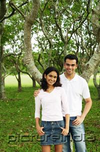 PictureIndia - Couple standing in park, looking at camera