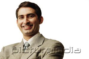 PictureIndia - Businessman, looking at camera, smiling, head shot