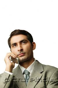 PictureIndia - Businessman using mobile phone, portrait