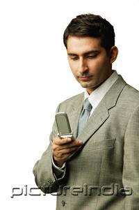 PictureIndia - Businessman looking at mobile phone