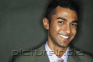 PictureIndia - Businessman looking at camera, smiling