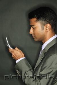 PictureIndia - Businessman using mobile phone, side view