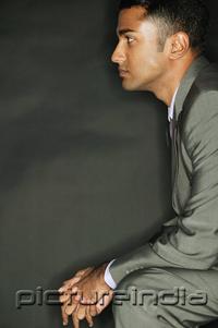 PictureIndia - Businessman sitting, side view, hands clasped