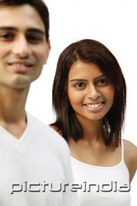 PictureIndia - Woman smiling at camera, man in foreground