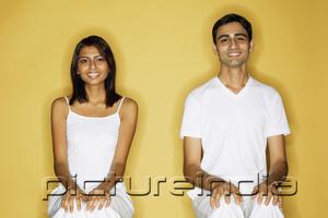 PictureIndia - Couple sitting apart, hands on knees, looking at camera