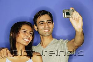 PictureIndia - Couple taking a picture of themselves, smiling